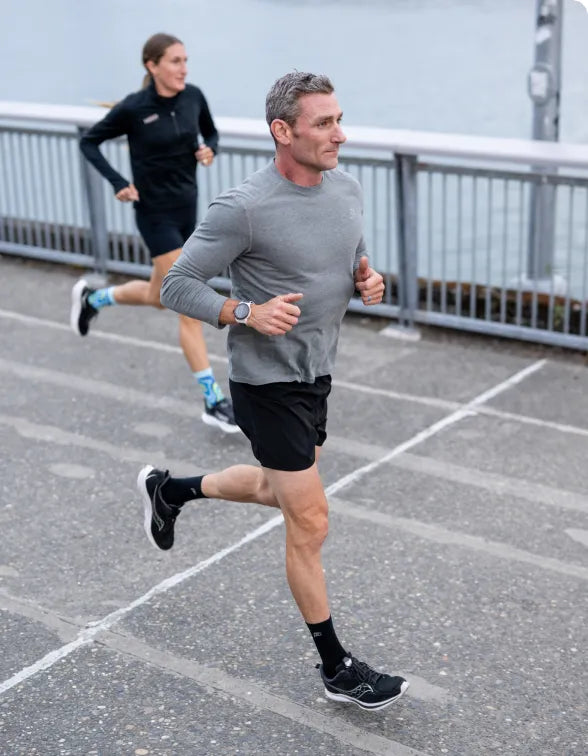 Man and Women running while wearing Superfeet Insoles