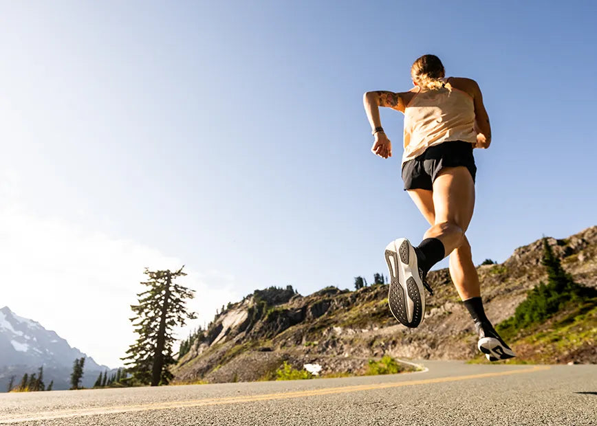 Woman running on road while wearing Superfeet insoles.