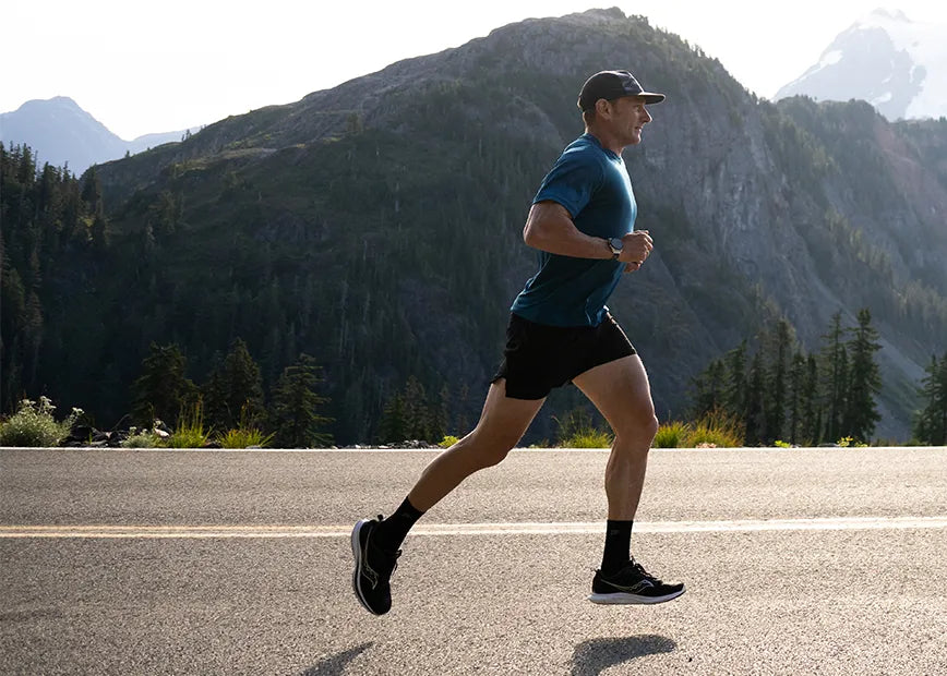 Man running on road while wearing Superfeet insoles.