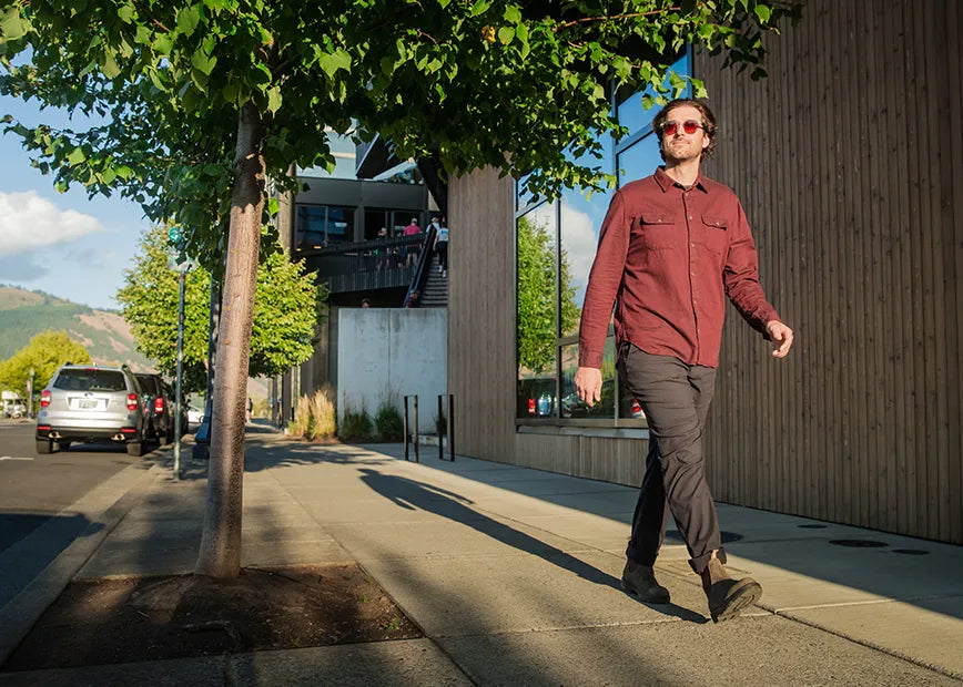 Man walking on sidewalk while wearing Superfeet insoles.