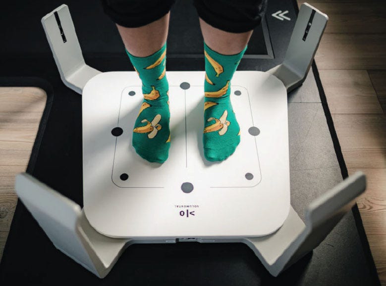 Precise measurements - person wearing socks standing on 3D foot scanning platform