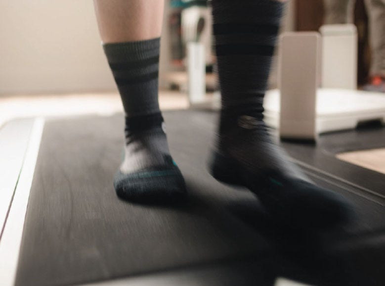 Dynamic Pressure - person wearing socks walking across a gait analyzing pressure plate