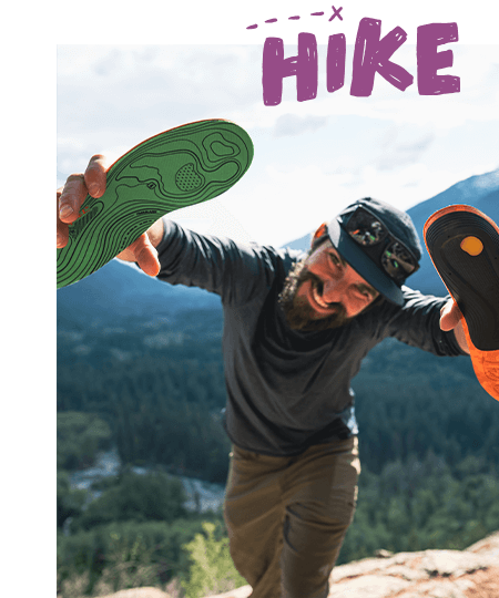 Smiling person presenting a pair of insoles to camera with hand drawn Hike text